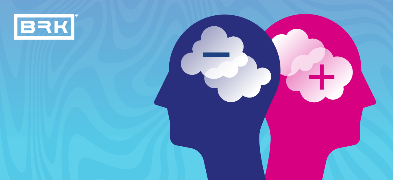 Two silhouetted heads symbolizing positive and negative thoughts