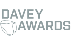 Logo for the Davey Awards, featuring stylized text and an abstract design element that resembles a gem or angular shape.