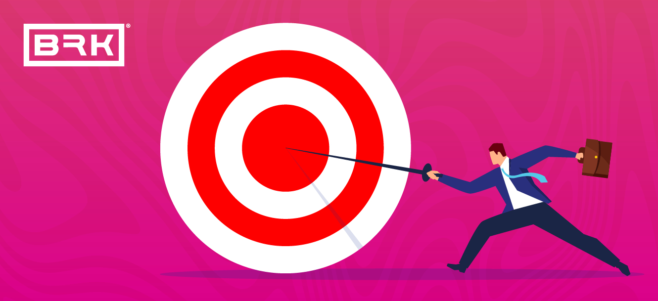 A person in a suit uses a fencing sword to strike the bullseye of a large target against a pink background. There is a "BRK" logo in the top left corner.