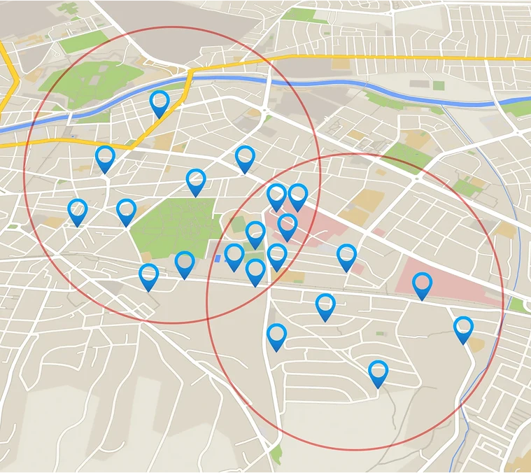 A city map with blue location pins and two overlapping red circles highlighting different areas.