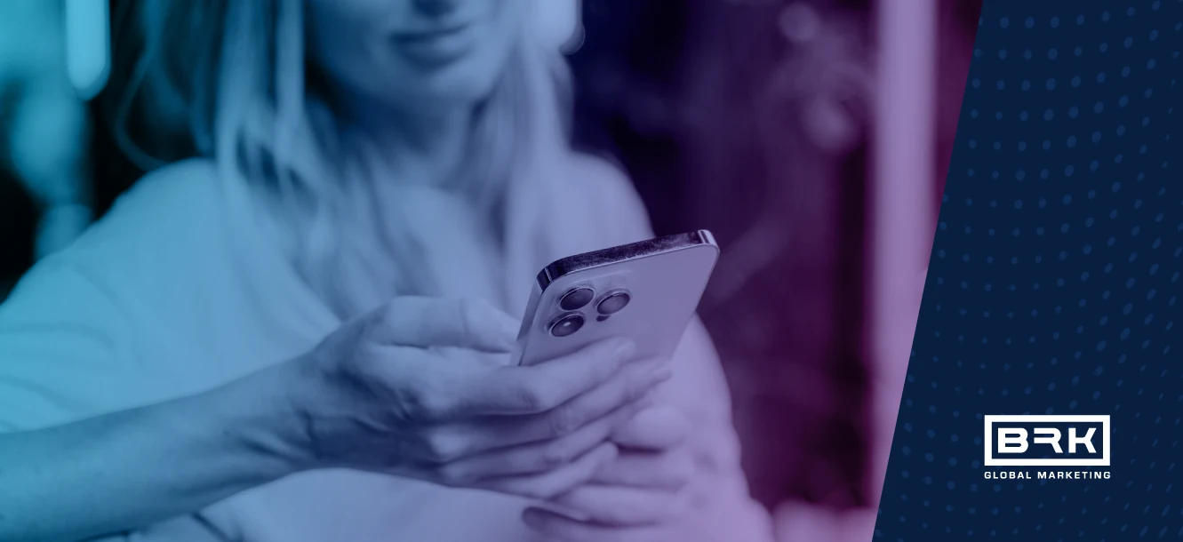 A person holds a smartphone, with the BRK Global Marketing logo in the bottom right corner.